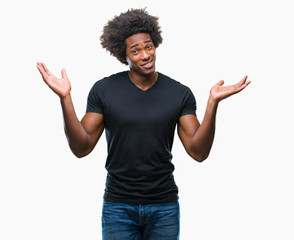 Afro american man over isolated background clueless and confused expression with arms and hands...