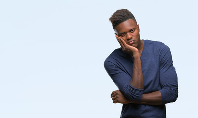 Young african american man over isolated background thinking looking tired and bored with depression problems with crossed arms.