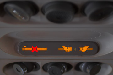 Airplane cabin detail, sengal no smoking and seat belt segnal