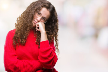 Fototapeta na wymiar Beautiful brunette curly hair young girl wearing glasses and winter sweater over isolated background thinking looking tired and bored with depression problems with crossed arms.
