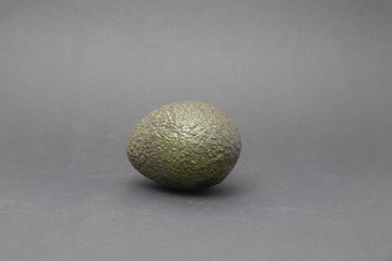 single avocado isolated on dark background