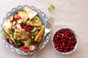 Fattush salad sprinkled with pomegranate seeds