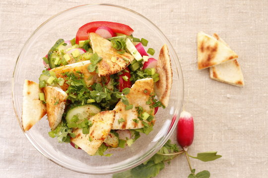 Fattush salad with pita pieces and radishes
