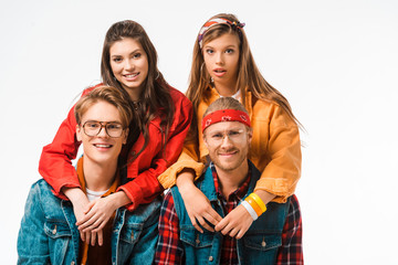 cheerful male hipsters sitting while their beautiful girlfriend standing behind isolated on white