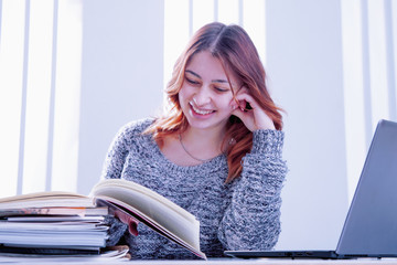 Money earning concept. Portrait of beautiful  pretty happy entrepreneur sitting at table in modern light workstation.