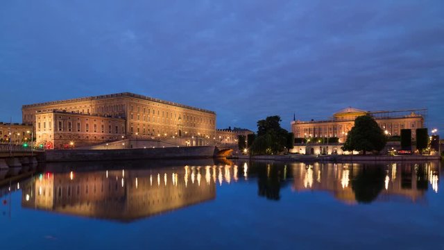 Sunset Night time lapse in Stockholm of the historic parliament house in Gamla Stan island with reflection on the water, Sweden
