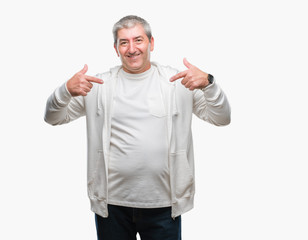 Handsome senior man wearing sport clothes over isolated background looking confident with smile on face, pointing oneself with fingers proud and happy.