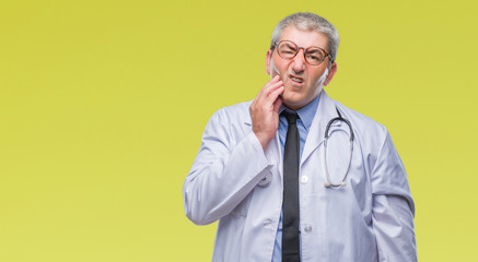 Handsome senior doctor man over isolated background touching mouth with hand with painful expression because of toothache or dental illness on teeth. Dentist concept.