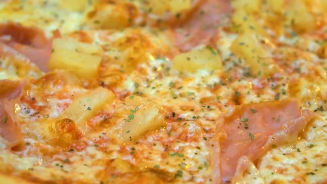 Crispy hot pizza with ham and pineapples.