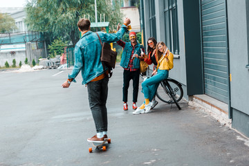 Obraz premium happy hipsters with skateboard and bicycle on street