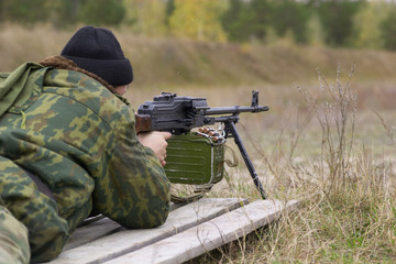 rusian soldier in uniform with machine gun
