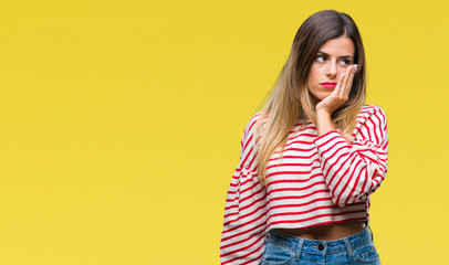 Young beautiful woman casual stripes winter sweater over isolated background thinking looking tired and bored with depression problems with crossed arms.