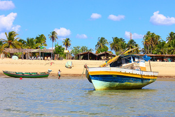 Fototapeta na wymiar Barra Grande, Piauí, Brazil. Boats, shallow water, beach, rustic restaurants and palm trees.