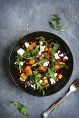 Pumpkin salad with beetroot, arugula and feta cheese.Top view.