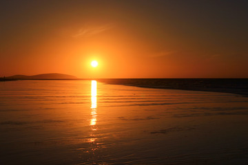 Sunset in Jericoacoara. Beautiful reflection on wet sand.