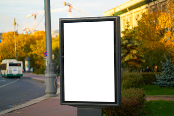 advertising space under the poster. Lightposter citylight mockup small billboard in the city near the roadway white space for advertising.