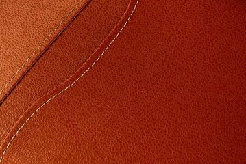 Orange leather with white stitch closeup for background.Part of leather motorcycle seat.