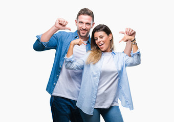 Fototapeta premium Young couple in love over isolated background looking confident with smile on face, pointing oneself with fingers proud and happy.