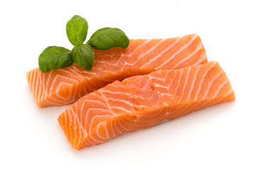 Fresh salmon fillet with basil on the white background.