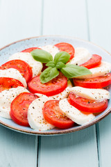 Classic caprese salad. Mozzarella tomatoes and  Basilikum.