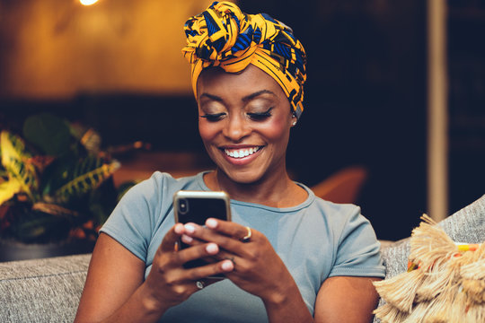 African American Woman wearing headscarf using smartphone - colorful