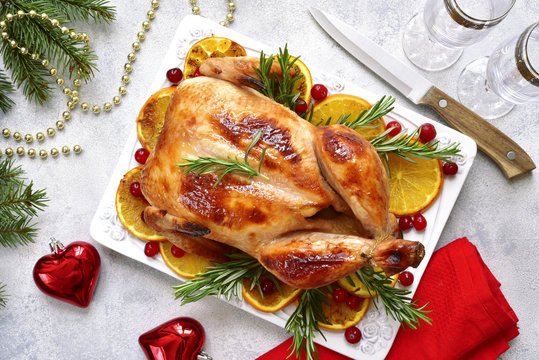 Roasted chicken with oranges , rosemary and cranberries.Top view with copy space.