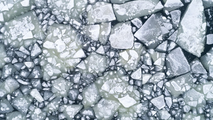 
floating ice floes on water, aerial view
