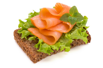 Bread with fresh salmon fillet isolated on white background, top view.