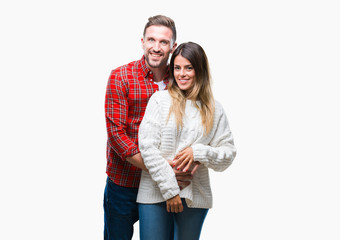 Young couple in love wearing winter sweater over isolated background with a happy and cool smile on face. Lucky person.
