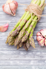 Bunch of fresh asparagus on wooden table.