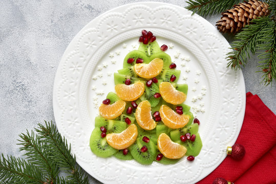 Edible christmas tree from kiwi and tangerine slices.Top view with copy space.