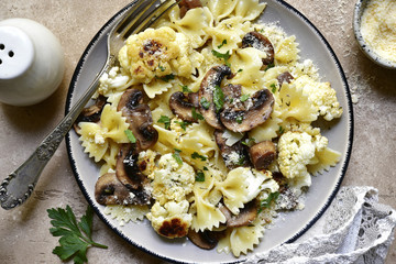 Farfalle pasta with mushrooms and cauliflower.Top vie with copy space.