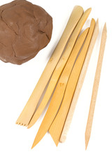 red clay and wooden modeling tools