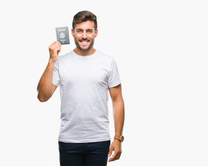 Young handsome man holding passport of united states over isolated background with a happy face...