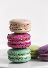 A bunch of colorful macaroons on a white background
