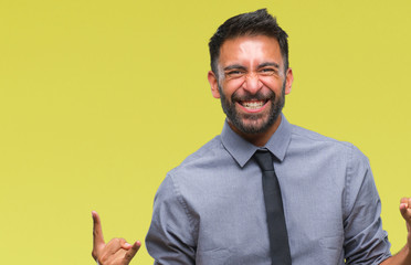 Adult hispanic business man over isolated background shouting with crazy expression doing rock symbol with hands up. Music star. Heavy concept.