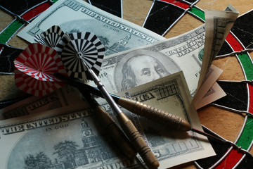 dart arrow hit the center target of dartboard and money
