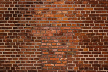 An old repaired orange red brick wall texture