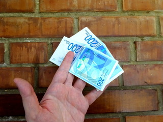 Money of Israel - 200 (two hundred) new shekels bills in the hand