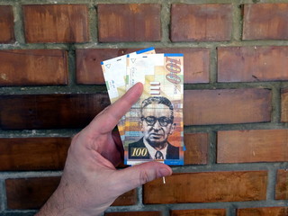 Money of Israel - 100 (one hundred) new shekels bills in the hand