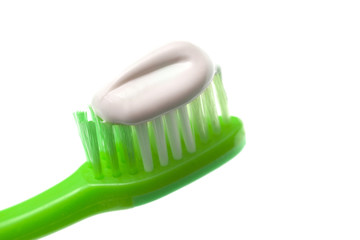 Simple Toothbrush on a White Background with Toothpaste Applied to the Bristles