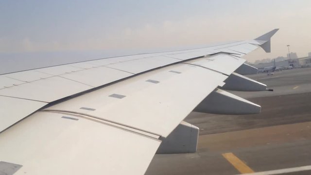 Taking off from Dubai International Airport as seen from window seat with view on wing.