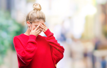 Young beautiful blonde woman wearing red sweater and glasses over isolated background with sad expression covering face with hands while crying. Depression concept.