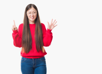 Young Chinese woman over isolated background wearing glasses showing and pointing up with fingers number six while smiling confident and happy.