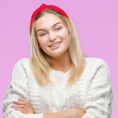 Young caucasian woman wearing winter sweater over isolated background happy face smiling with crossed arms looking at the camera. Positive person.