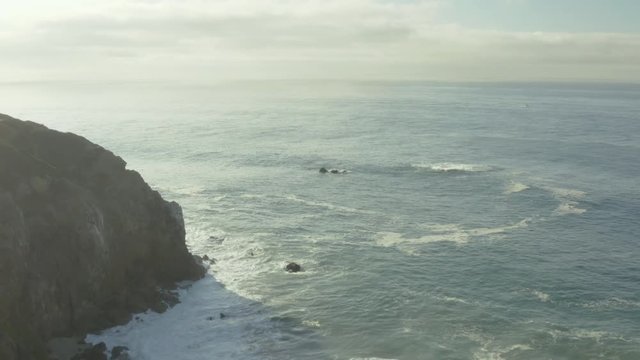 Aerial ascending shot and fly over of a cliff on the beach.