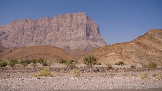 Steady driving shot while approaching the Jebel Shams mountains in the Sultanate of Oman.