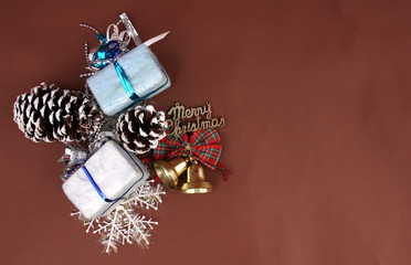 Gift Box and Christmas Decoration with Brown Backdrop.