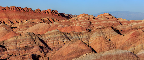 Zhangye Danxia National Geopark - Gansu Province, China. Chinese Danxia multicolor danxia landform, rainbow hills, unusual colored rocks, sandstone erosion, layers of Red, Yellow and Orange stripes.
