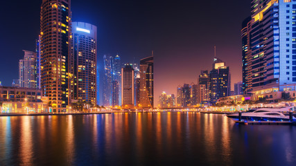 Fototapeta na wymiar Beautiful view to Dubai Marina, UAE. City skyline. Long exposure time lapse effect at night